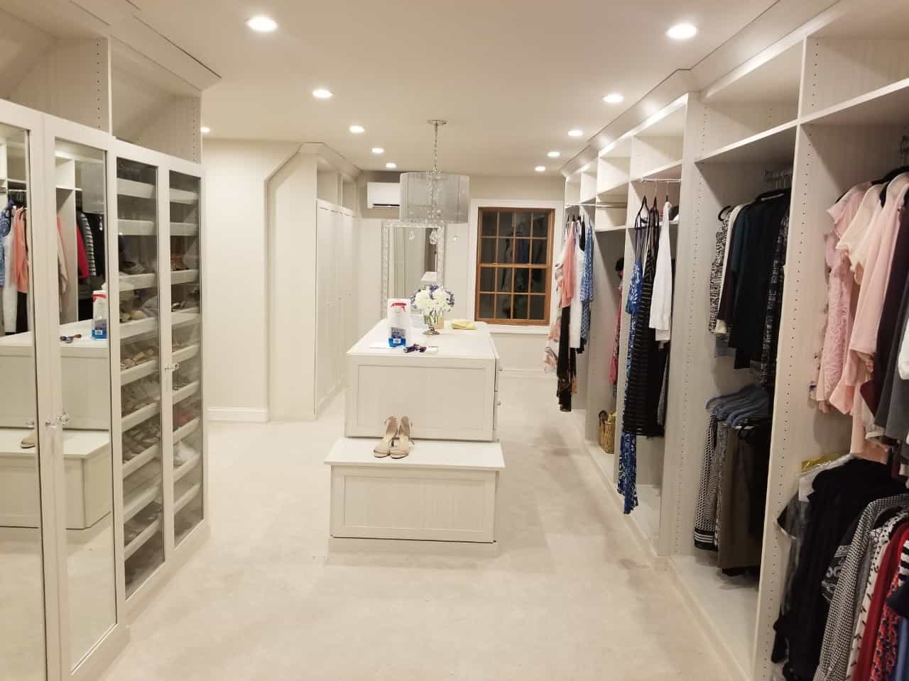 A custom walk-in closet from Closets by Design with island.