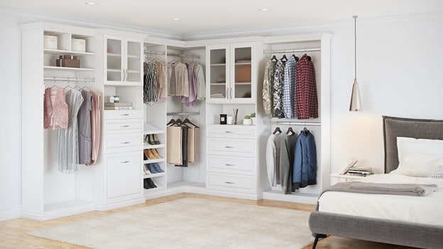A custom walk-in closet with a white finish.