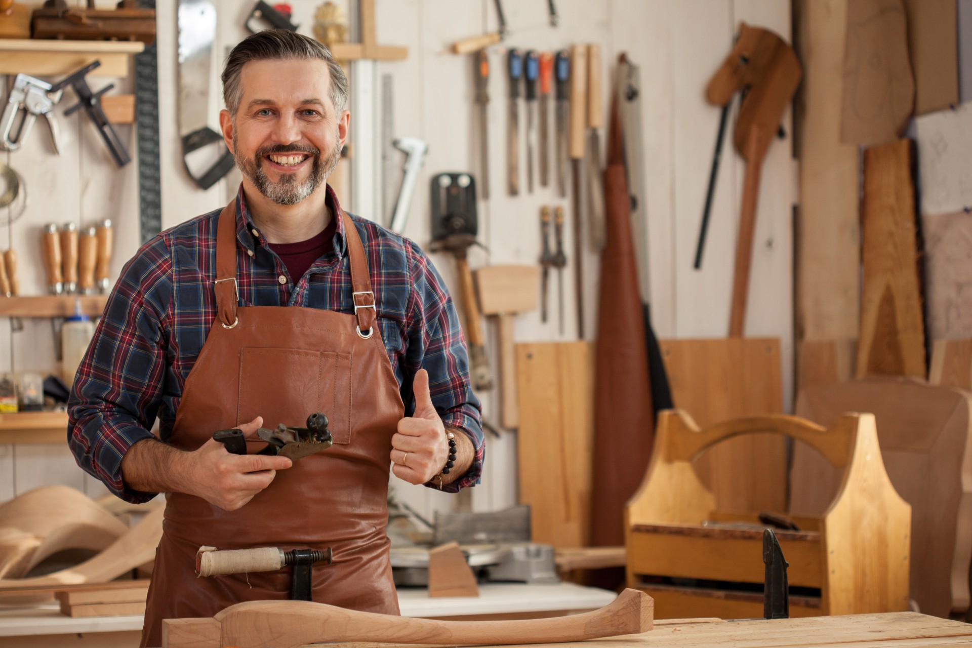 A carpenter standing in his workshop.