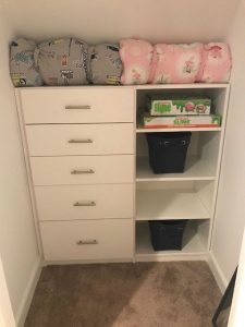 A child's closet organized with shelves and drawers.