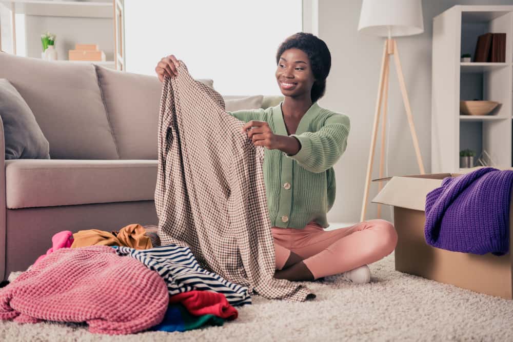Woman unpacking clothes after a move