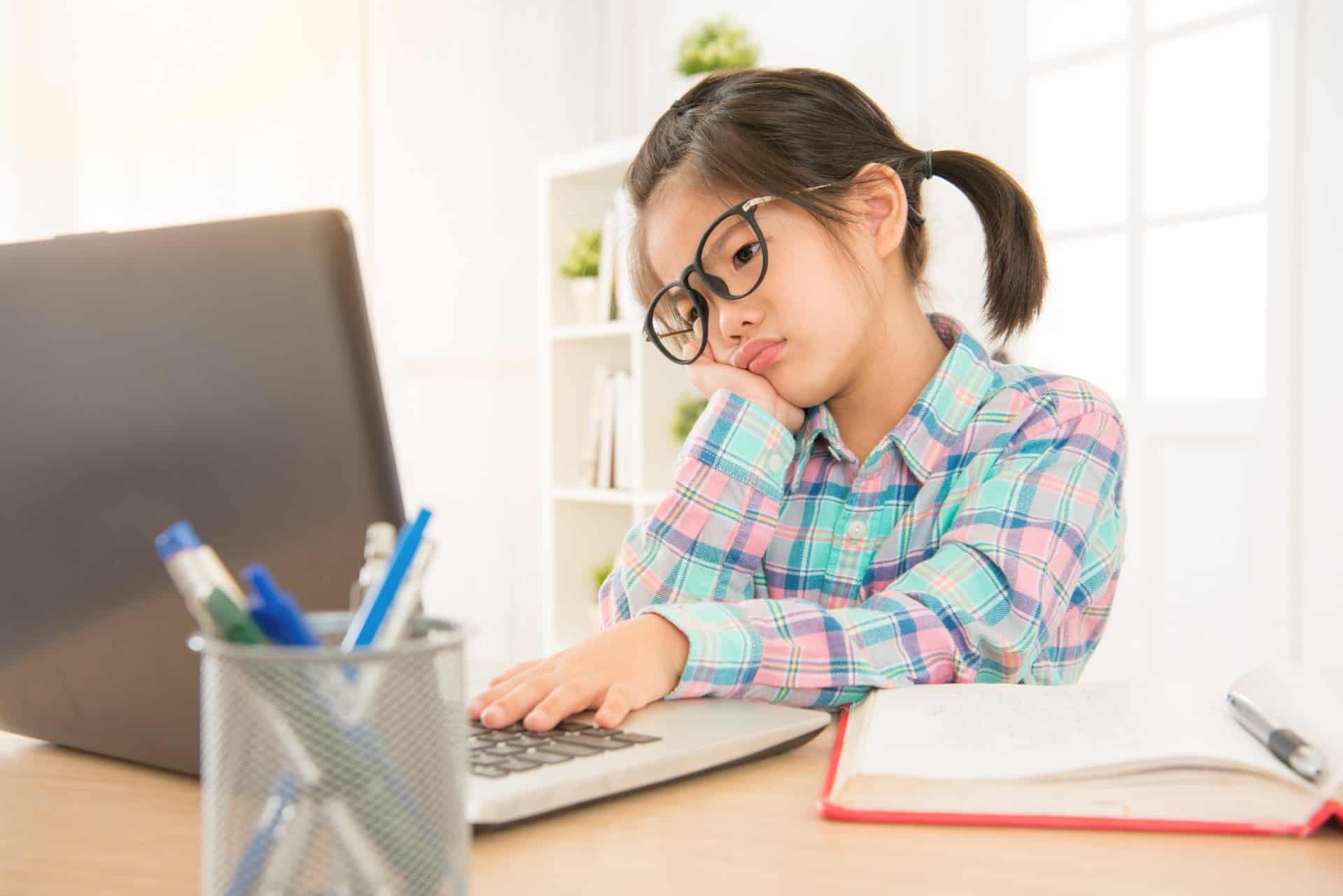 A young girl learning online from home.