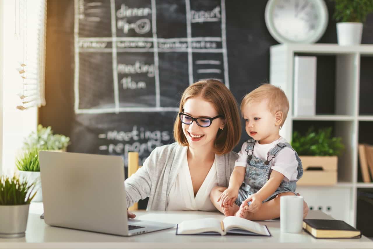 A mother and her young son working from a home office.