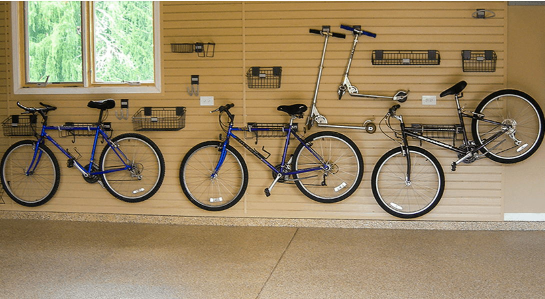 Bicycles hanging on a garage wall.